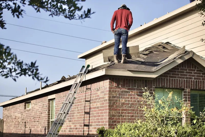 Professional roofer working on a residential roof in Royal Oak Golf Country Club